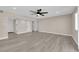 Open living room with updated laminate floors and ceiling fan at 608 W Mcdermit St, Las Vegas, NV 89107