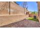 Private backyard featuring low-maintenance landscaping with brick pavers and synthetic lawn at 632 Twilight Blue Ave, North Las Vegas, NV 89032