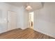 Neutral room with wood-look flooring, white door, and natural lighting at 632 Twilight Blue Ave, North Las Vegas, NV 89032