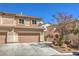 Inviting two-story townhome featuring attached two-car garage and desert landscaping at 632 Twilight Blue Ave, North Las Vegas, NV 89032