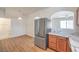 Modern kitchen boasts stainless steel refrigerator and archway to an adjacent space at 632 Twilight Blue Ave, North Las Vegas, NV 89032