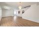 Bright living room featuring wood flooring, white walls, and modern light fixture at 632 Twilight Blue Ave, North Las Vegas, NV 89032