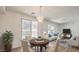 Bright living room with dining area, wood floors, modern lighting and sliding glass door to a private backyard at 632 Twilight Blue Ave, North Las Vegas, NV 89032