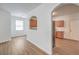 Open living room with wood floors, neutral walls, and arched entryway to kitchen at 632 Twilight Blue Ave, North Las Vegas, NV 89032