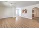 Large living area featuring an open concept with sleek flooring, an open staircase and a window to the kitchen at 632 Twilight Blue Ave, North Las Vegas, NV 89032