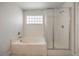 Bright main bathroom featuring a bathtub and a glass-enclosed shower at 632 Twilight Blue Ave, North Las Vegas, NV 89032