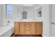 Bathroom features double sink vanity, tile backsplash, and wood-style flooring at 648 Sumatra Pl, Henderson, NV 89011