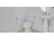 Bathroom features a white toilet, pedestal sink and tile flooring at 648 Sumatra Pl, Henderson, NV 89011