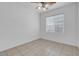 This cozy bedroom features tiled floors, a window, and a ceiling fan for added comfort at 648 Sumatra Pl, Henderson, NV 89011