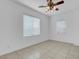 This cozy bedroom features tiled floors, two windows, and a ceiling fan for added comfort at 648 Sumatra Pl, Henderson, NV 89011