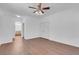 Bedroom with ceiling fan and hardwood-style flooring flows to bathroom at 648 Sumatra Pl, Henderson, NV 89011