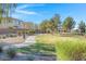 A serene community park offers walking paths, grassy areas, mature trees, and comfortable seating for relaxation at 648 Sumatra Pl, Henderson, NV 89011