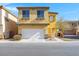 Two-story home with a two-car garage, desert landscaping, and a charming entryway at 648 Sumatra Pl, Henderson, NV 89011