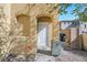 Close-up of front door with arched entryway and desert landscaping at 648 Sumatra Pl, Henderson, NV 89011