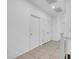 Hallway features neutral tile flooring, fresh white paint, and closet space at 648 Sumatra Pl, Henderson, NV 89011