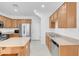 Kitchen features stainless appliances, granite countertops, wooden cabinetry, and center island at 648 Sumatra Pl, Henderson, NV 89011