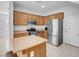 Well-lit kitchen with stainless steel appliances and ample cabinet space at 648 Sumatra Pl, Henderson, NV 89011