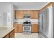 Kitchen features stainless steel appliances, granite countertops, wooden cabinetry and breakfast bar at 648 Sumatra Pl, Henderson, NV 89011