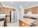 Bright eat-in kitchen features stainless appliances, granite countertops, wooden cabinetry, and kitchen island with breakfast bar at 648 Sumatra Pl, Henderson, NV 89011
