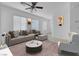 Bright living room with neutral furniture and a view of an open floorplan at 648 Sumatra Pl, Henderson, NV 89011