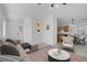 Bright living room with neutral furniture and an open floorplan at 648 Sumatra Pl, Henderson, NV 89011