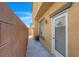 This is an image of a side yard with a concrete walkway and a door that provides easy access from the home at 648 Sumatra Pl, Henderson, NV 89011