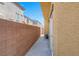This is a picture of the side yard that connects to the main home with a door leading to a walkway made of concrete at 648 Sumatra Pl, Henderson, NV 89011