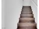 Staircase features dark wood steps and white walls at 648 Sumatra Pl, Henderson, NV 89011