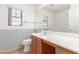 Bathroom featuring a sink, toilet and window for natural light at 6489 Coldwater Bay Dr, Las Vegas, NV 89122