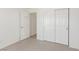 Bedroom with neutral carpet flooring, white walls, closet, and an interior door at 6489 Coldwater Bay Dr, Las Vegas, NV 89122