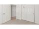 Bedroom with neutral carpet flooring, white walls, closet, and an interior door at 6489 Coldwater Bay Dr, Las Vegas, NV 89122