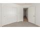 Bedroom with neutral carpet flooring, white walls, closet, and an interior door at 6489 Coldwater Bay Dr, Las Vegas, NV 89122