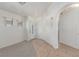 Clean, bright entryway featuring tile and carpet flooring, a decorative front door, and an archway at 6489 Coldwater Bay Dr, Las Vegas, NV 89122