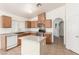 Bright kitchen boasts wood cabinets, an island, stainless steel appliances, and tile flooring at 6489 Coldwater Bay Dr, Las Vegas, NV 89122