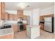 Modern kitchen features wood cabinets, stainless steel appliances, and a functional center island at 6489 Coldwater Bay Dr, Las Vegas, NV 89122