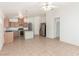 Open kitchen features wood cabinets, tile flooring, an island, and stainless steel appliances at 6489 Coldwater Bay Dr, Las Vegas, NV 89122