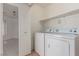 Laundry room with a side-by-side washer and dryer and shelving for storage at 6489 Coldwater Bay Dr, Las Vegas, NV 89122
