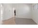 Bright, neutral living room with tile and carpet flooring, white walls, and arched doorway at 6489 Coldwater Bay Dr, Las Vegas, NV 89122