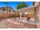 Relaxing covered patio with stone and gravel yard perfect for entertaining in the backyard at 6625 Pine Siskin Pl, North Las Vegas, NV 89084