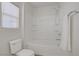 Bright and clean bathroom featuring a toilet, bathtub, and shower with modern fixtures and ample natural light at 6625 Pine Siskin Pl, North Las Vegas, NV 89084
