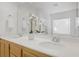 Bright bathroom featuring a double sink vanity, modern faucets, and a large mirror reflecting a clean, well-lit space at 6625 Pine Siskin Pl, North Las Vegas, NV 89084