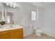 Bright bathroom with a single sink vanity, a toilet, and a shower-tub combo, offering a clean and functional space at 6625 Pine Siskin Pl, North Las Vegas, NV 89084