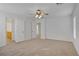 Bright and airy bedroom with three doors, a ceiling fan and soft carpet, creating a comfy space at 6625 Pine Siskin Pl, North Las Vegas, NV 89084