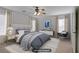 Staged bedroom with soft gray walls, plush bedding, and natural light for a calming atmosphere at 6625 Pine Siskin Pl, North Las Vegas, NV 89084
