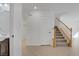 Hallway with staircase, neutral tile flooring, access to rooms and a half bathroom at 6625 Pine Siskin Pl, North Las Vegas, NV 89084