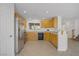 Bright kitchen with stainless steel appliances, light wood cabinets, and a breakfast bar at 6625 Pine Siskin Pl, North Las Vegas, NV 89084
