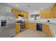 Well-lit kitchen features stainless steel appliances, tile flooring, wood cabinets and granite counters at 6625 Pine Siskin Pl, North Las Vegas, NV 89084
