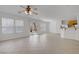 Open living space with bright lighting, sliding door and tile floors leading to the kitchen at 6625 Pine Siskin Pl, North Las Vegas, NV 89084