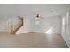 Spacious living room featuring a staircase and open floor plan, with tile flooring at 6625 Pine Siskin Pl, North Las Vegas, NV 89084
