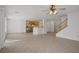 Spacious open living room with tile floors, leading to the kitchen and a staircase at 6625 Pine Siskin Pl, North Las Vegas, NV 89084